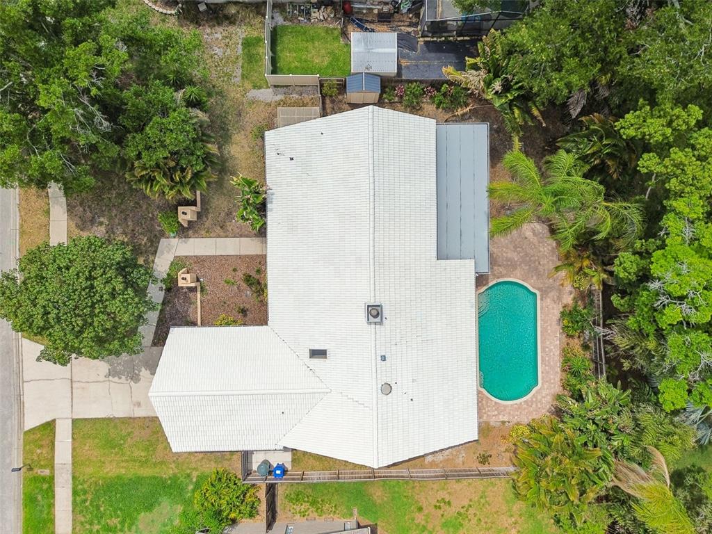 1470 Burnham Lane Dunedin, FL 34698 - Photo 38 of 42 aerial view of a house with swimming pool and trees