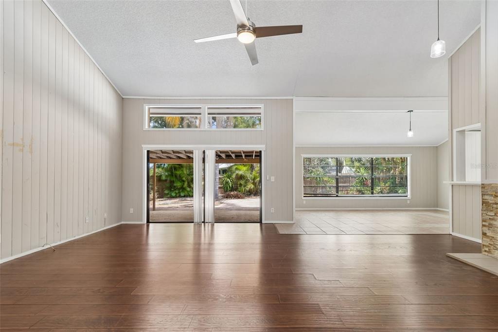 1470 Burnham Lane Dunedin, FL 34698 - Photo 4 of 42 a view of an empty room with wooden floor and a window