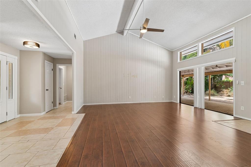 1470 Burnham Lane Dunedin, FL 34698 - Photo 5 of 42 a view of an empty room with wooden floor and a window