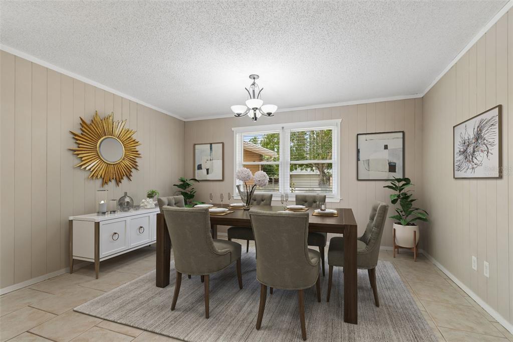 1470 Burnham Lane Dunedin, FL 34698 - Photo 9 of 42 a dining room with furniture a window and a chandelier