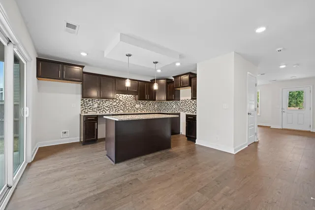 a large kitchen with a stove and a refrigerator