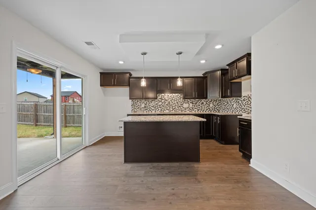 a large kitchen with a stove and a refrigerator