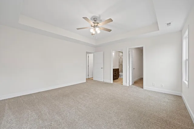 a view of an empty room with a ceiling fan