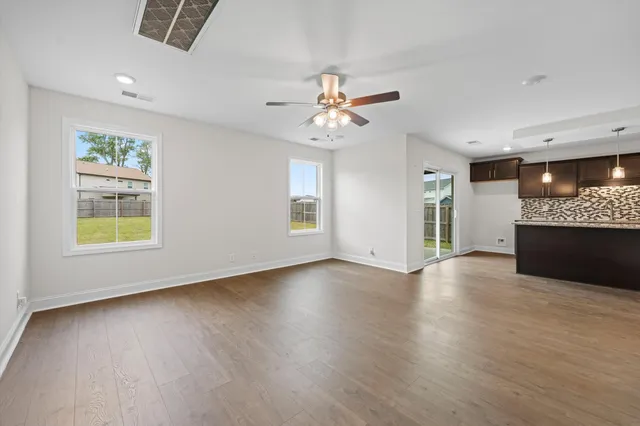 a view of a kitchen with a dishwasher cabinets and a floor to ceiling window
