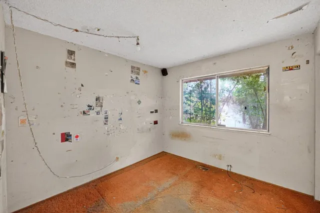 a view of a room with window and ceiling fan