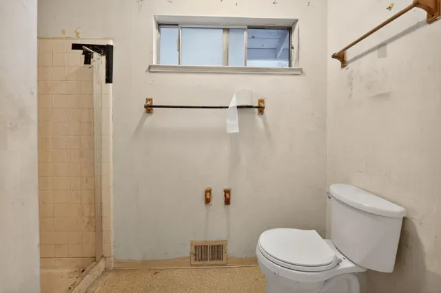 a white toilet sitting next to a bathroom sink