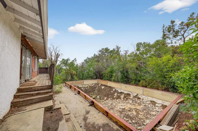 a view of a house with a tree in the background
