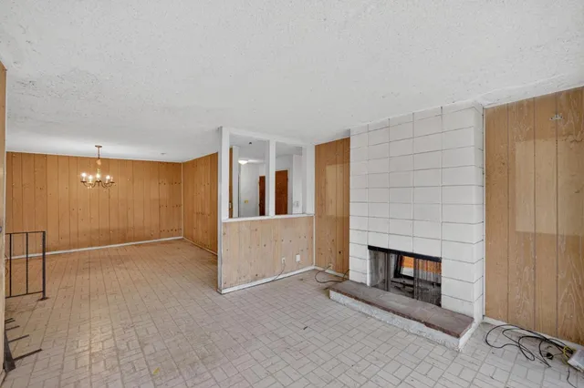 a view of a livingroom with an empty space and a fireplace