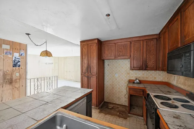 a kitchen with a stove and a refrigerator