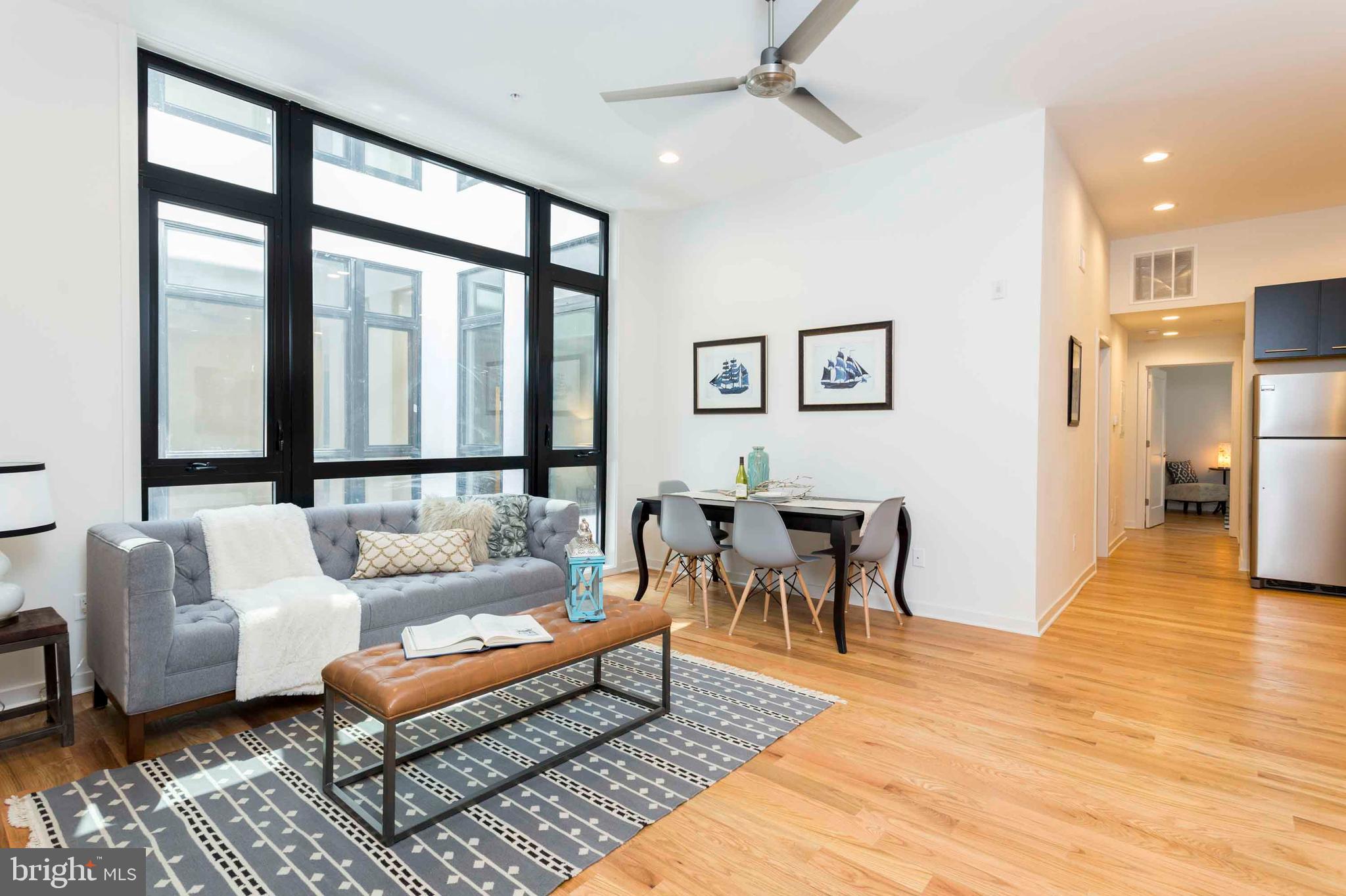 2028-34 Rittenhouse Square, Unit 102 Philadelphia, PA 19103 - Photo 1 of 13 a living room with furniture and a table