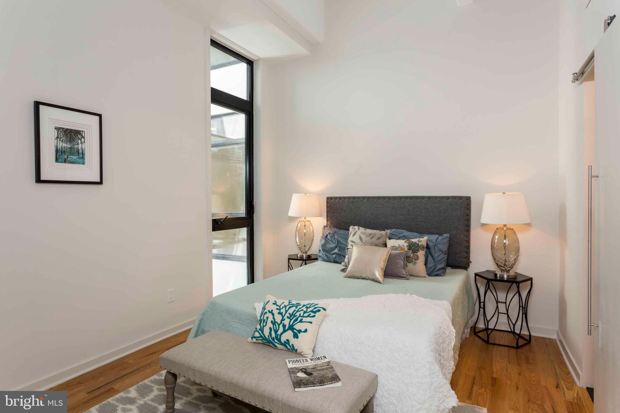 2028-34 Rittenhouse Square, Unit 102 Philadelphia, PA 19103 - Photo 11 of 13 a bedroom with a bed and wooden floor