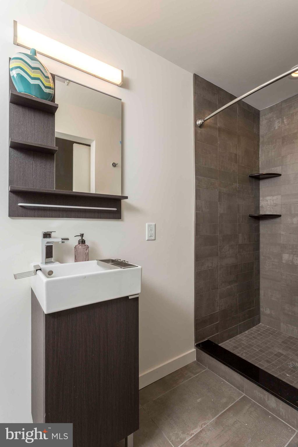 2028-34 Rittenhouse Square, Unit 102 Philadelphia, PA 19103 - Photo 12 of 13 a bathroom with a sink and a mirror