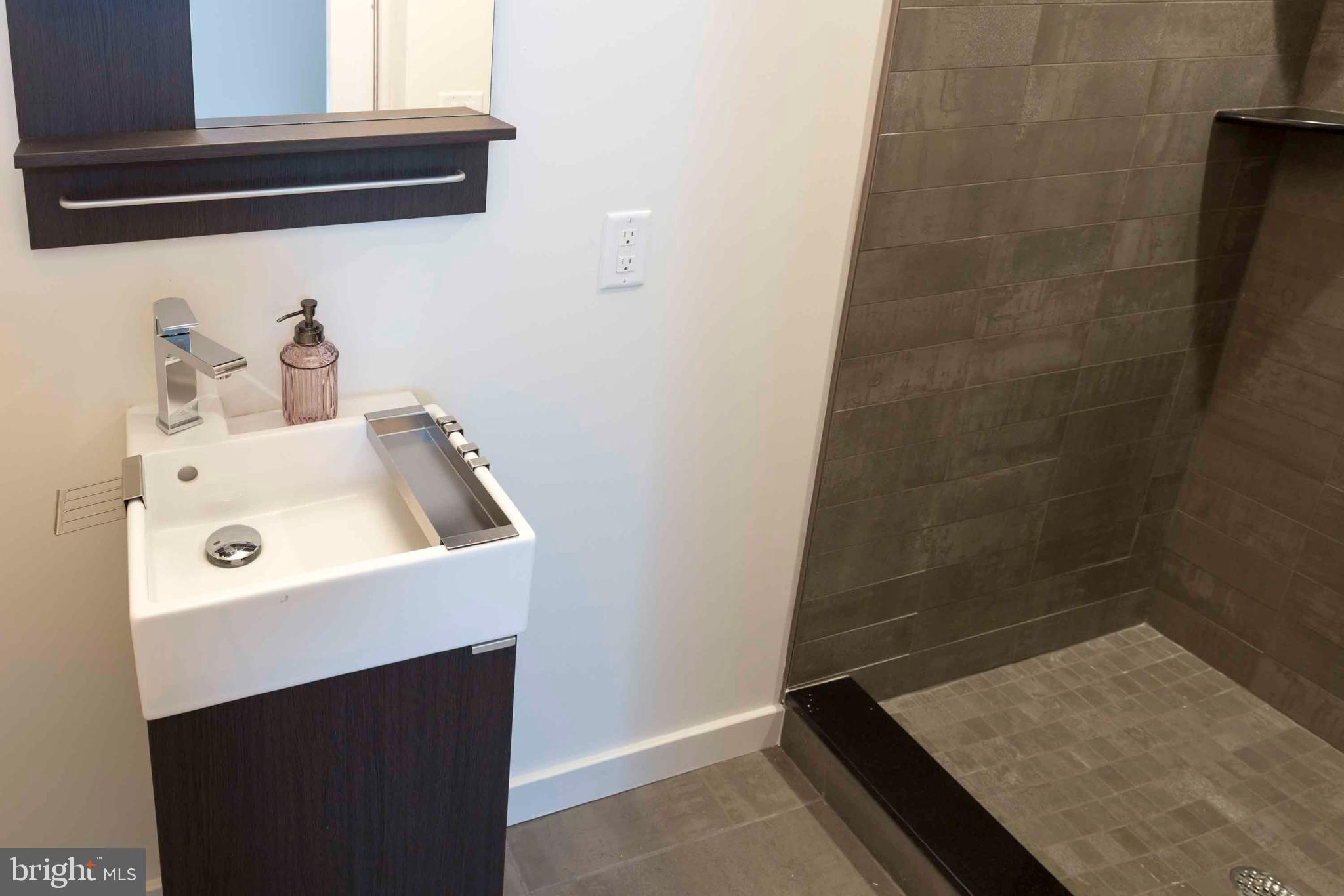 2028-34 Rittenhouse Square, Unit 102 Philadelphia, PA 19103 - Photo 13 of 13 a bathroom with a sink and a washing machine