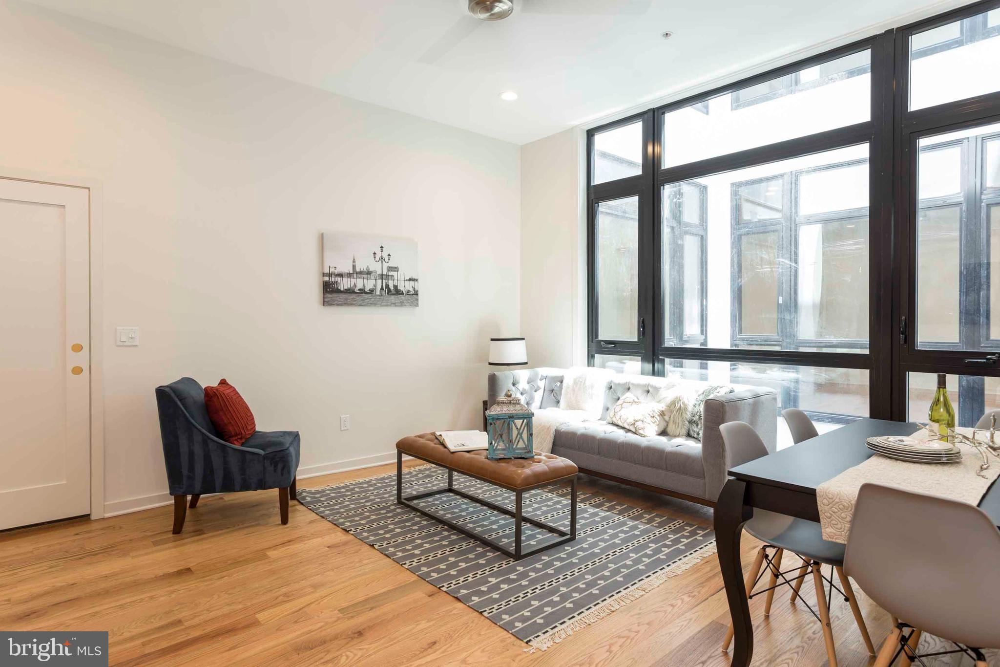 2028-34 Rittenhouse Square, Unit 102 Philadelphia, PA 19103 - Photo 3 of 13 a living room with furniture and a large window