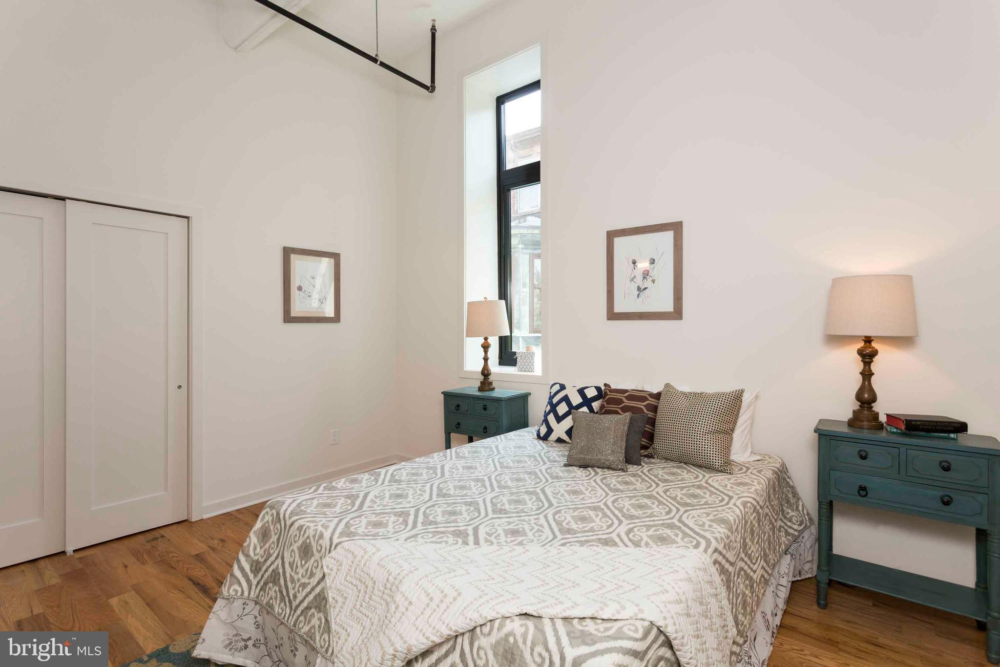 2028-34 Rittenhouse Square, Unit 102 Philadelphia, PA 19103 - Photo 4 of 13 a bedroom with a bed and a window