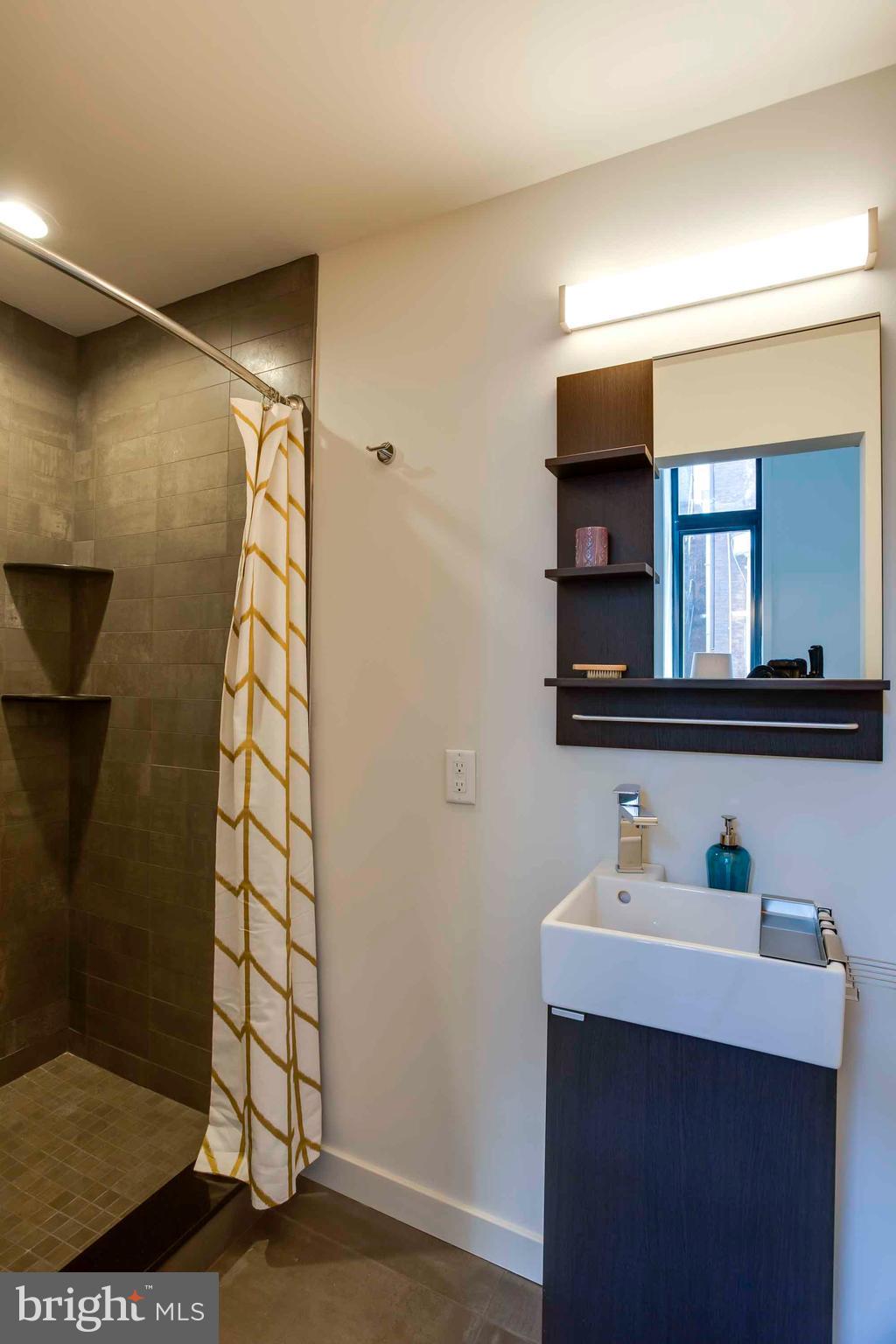 2028-34 Rittenhouse Square, Unit 102 Philadelphia, PA 19103 - Photo 5 of 13 a bathroom with a sink and a mirror