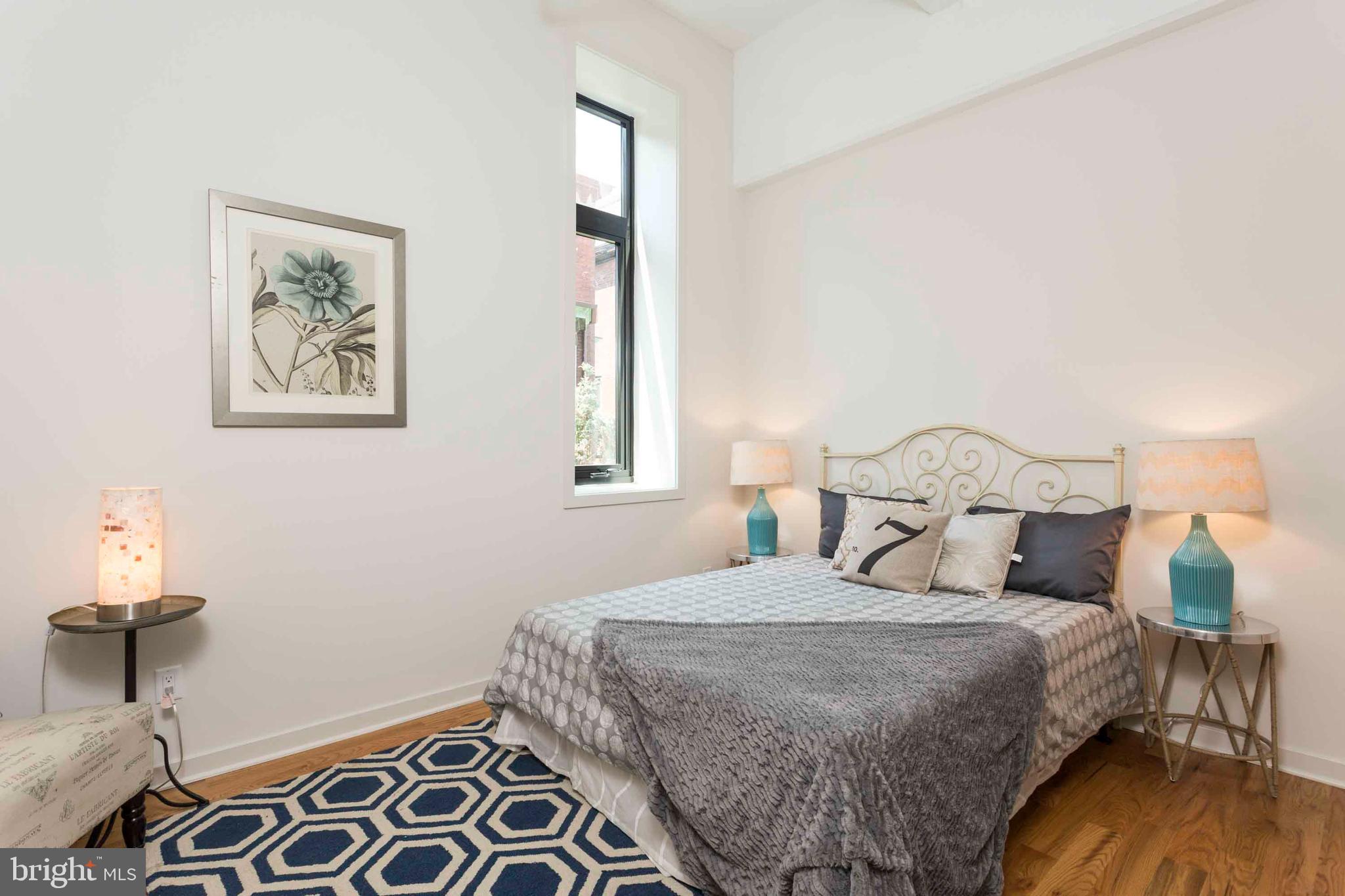 2028-34 Rittenhouse Square, Unit 102 Philadelphia, PA 19103 - Photo 8 of 13 a bedroom with a bed and a painting on the wall