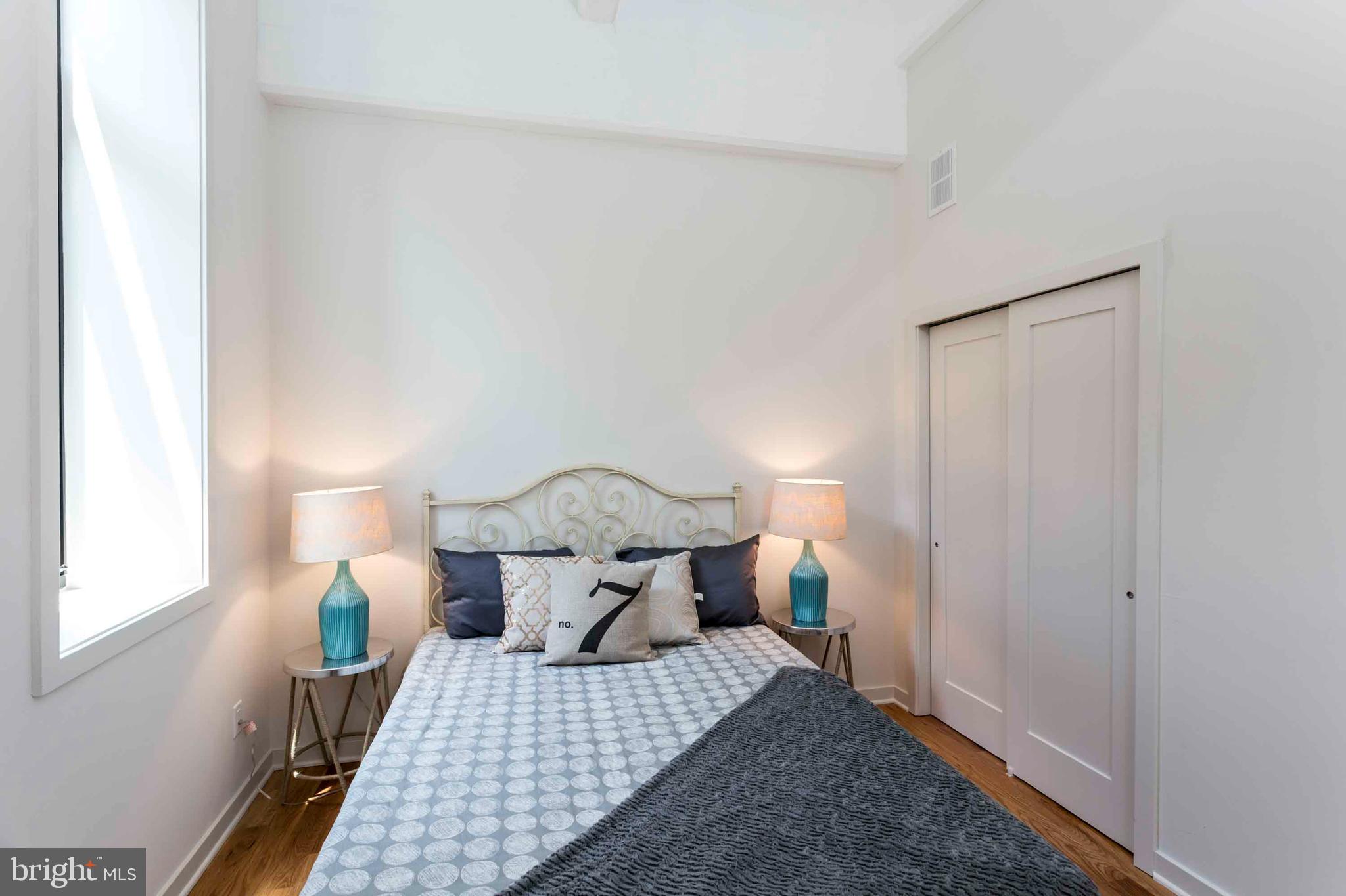 2028-34 Rittenhouse Square, Unit 102 Philadelphia, PA 19103 - Photo 9 of 13 a bedroom with a bed and a window