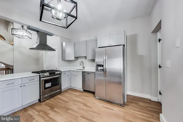 a kitchen with stainless steel appliances granite countertop a stove a refrigerator and a refrigerator