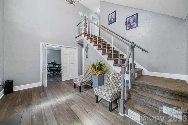 a view of entryway and hall with wooden floor