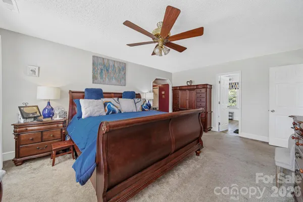 a bed room with a bed and a ceiling fan