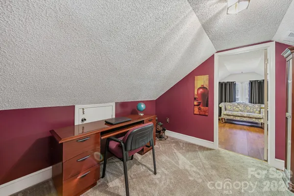 a bedroom with a bed couch and a window