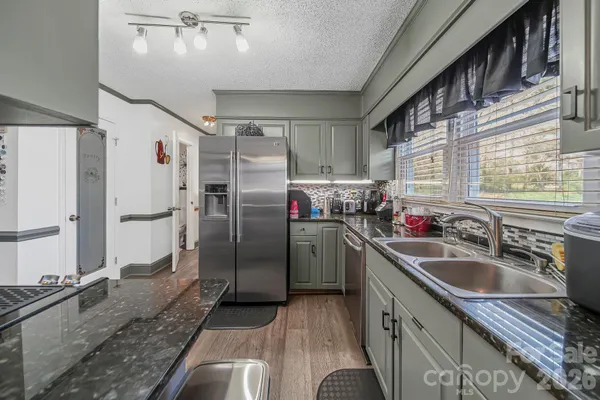 a kitchen with refrigerator sink and stainless steel appliances