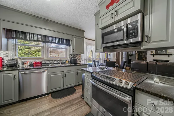 a kitchen with stainless steel appliances granite countertop a stove and a sink