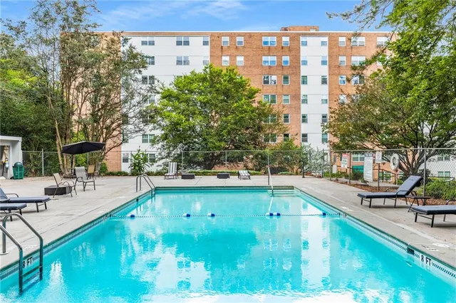 a view of swimming pool with outdoor seating and plants