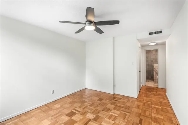 a view of a room with a ceiling fan