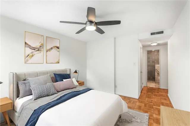 a bedroom with a bed and a painting on the wall