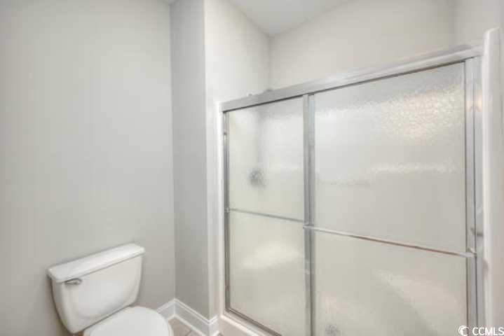70 Addison Cottage Way, Unit 319 Murrells Inlet, SC 29576 - Photo 12 of 30 Bathroom with a shower stall and toilet