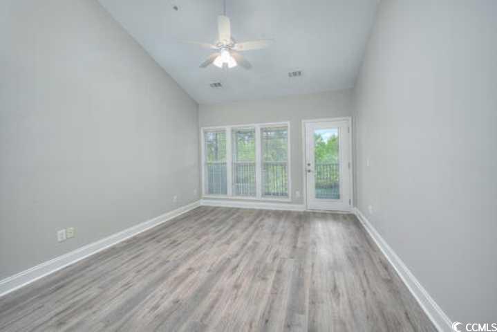70 Addison Cottage Way, Unit 319 Murrells Inlet, SC 29576 - Photo 18 of 30 Spare room with lofted ceiling, light wood-style floors, and ceiling fan