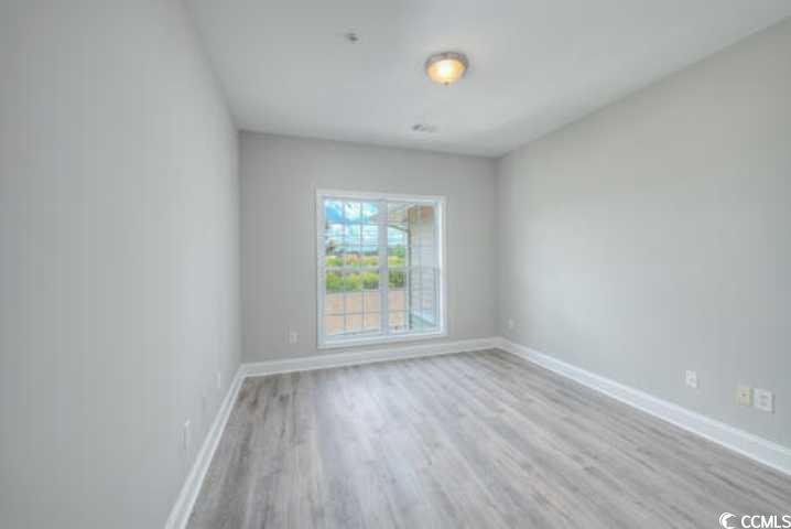70 Addison Cottage Way, Unit 319 Murrells Inlet, SC 29576 - Photo 21 of 30 Unfurnished room featuring baseboards and light wood finished floors