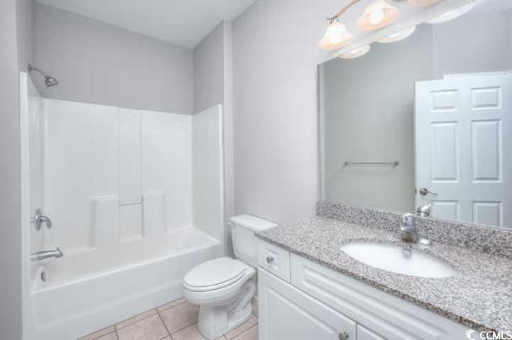 70 Addison Cottage Way, Unit 319 Murrells Inlet, SC 29576 - Photo 25 of 30 Full bathroom featuring shower combination, vanity, and light tile patterned flooring