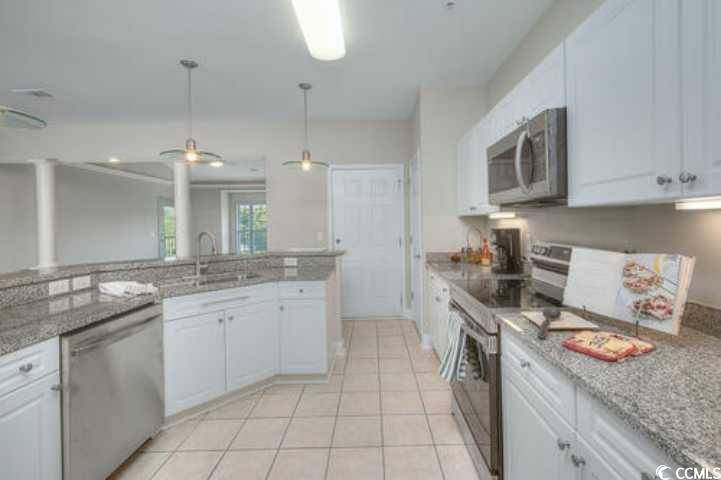 70 Addison Cottage Way, Unit 319 Murrells Inlet, SC 29576 - Photo 4 of 30 Kitchen with white cabinetry, stainless steel appliances, light stone counters, light tile patterned floors, and pendant lighting
