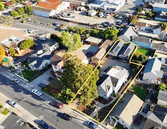 an aerial view of multiple houses with yard