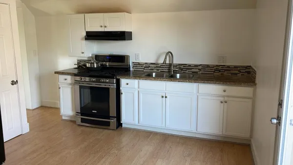 a kitchen with cabinets and appliances
