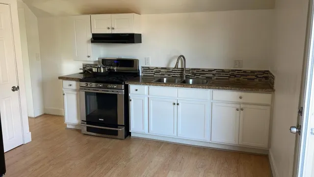 a kitchen with cabinets and appliances