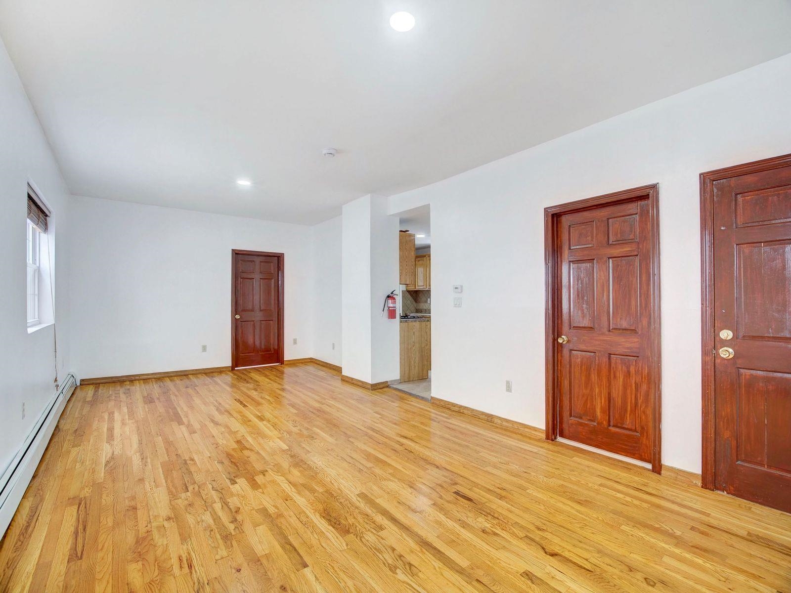 921 Paterson Plank Road, Unit 2 North Bergen, NJ 07047 - Photo 9 of 15 a view of an empty room with wooden floor