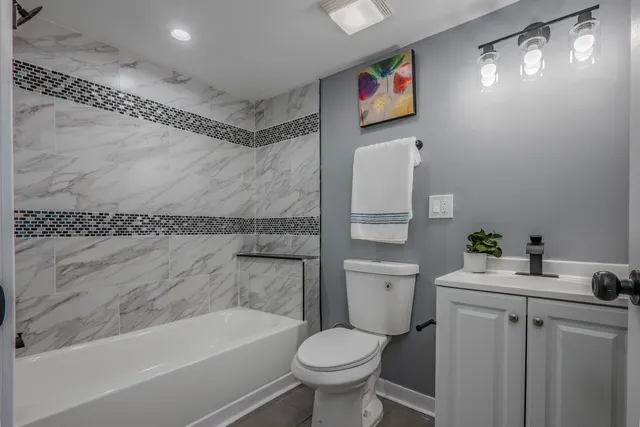 a bathroom with a bath tub and shower