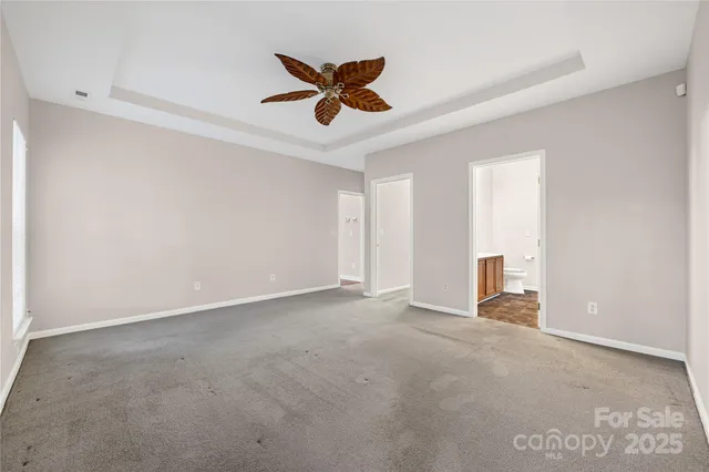 a view of empty room with wooden floor and fireplace