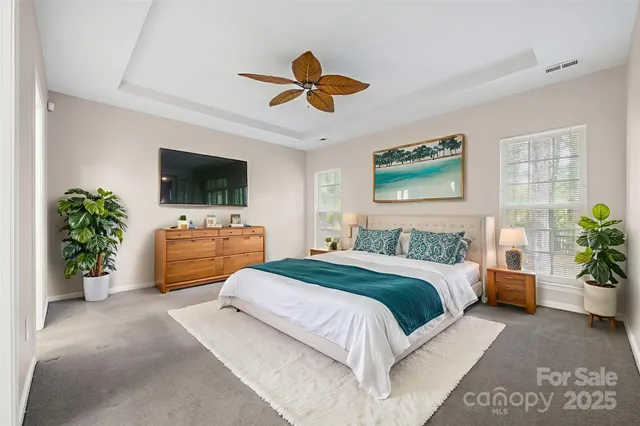 a bedroom with a bed furniture and a flat screen tv