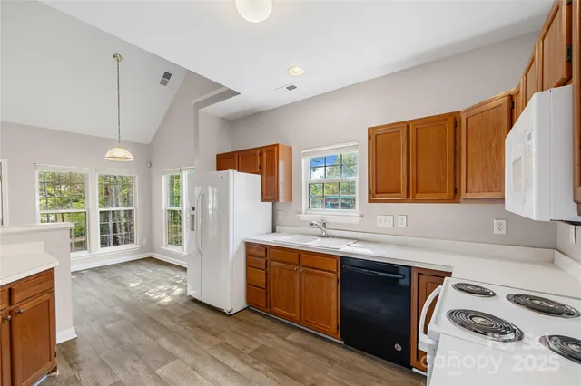 a kitchen with a sink a stove and cabinets