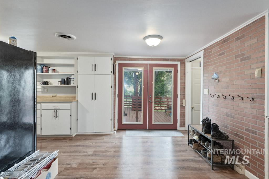 259 Highway 12 Pomeroy, WA 99347 - Photo 5 of 45 Wood-finish flooring throughout, complemented by a brick accent wall and white trim