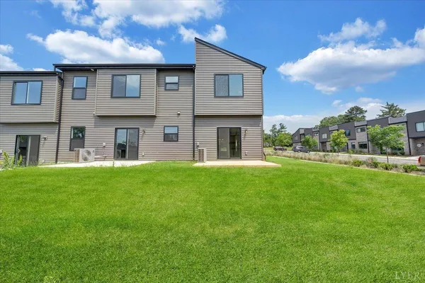 a large brick building with a yard in front of it
