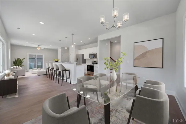 a view of a dining room with furniture wooden floor and chandelier