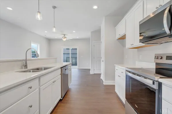 a kitchen with a sink stainless steel appliances and cabinets