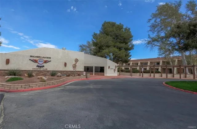 a view of grassy field with benches and trees all around