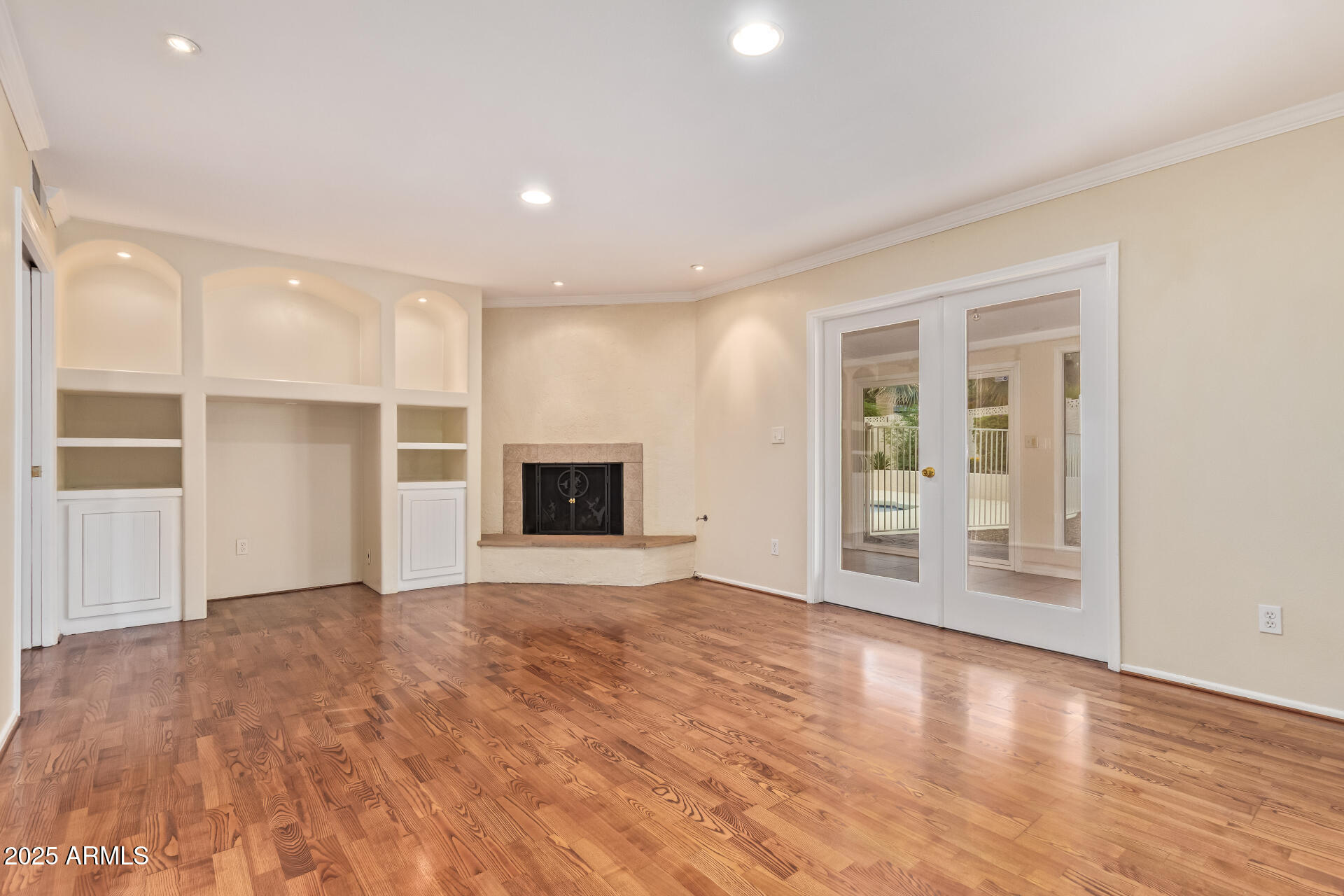 2234 East Lawrence Road Phoenix, AZ 85016 - Photo 12 of 71 a view of empty room with wooden floor and fireplace